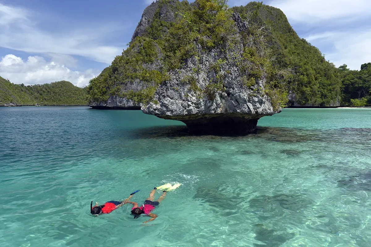 a couple that is scubadiving around the coast of indonesia