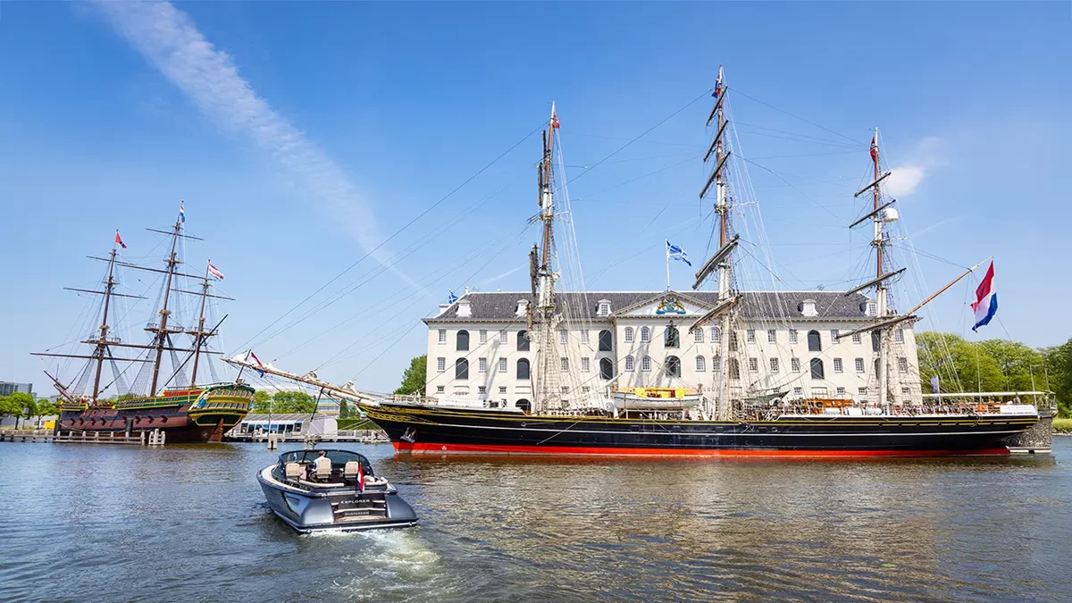 A Boat sailing near old vessels